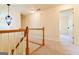 Carpeted hallway and wood railing overlook the entry way and living spaces at 165 Mcelwaney Way, Fayetteville, GA 30215