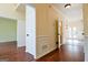 Hallway showcasing hardwood floors and doorway views to other rooms at 165 Mcelwaney Way, Fayetteville, GA 30215