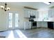 Charming kitchen with stainless steel appliances, modern cabinets and a door to the backyard at 165 Mcelwaney Way, Fayetteville, GA 30215