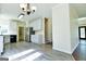 Open-concept kitchen with white cabinets, stainless steel appliances, and island at 165 Mcelwaney Way, Fayetteville, GA 30215