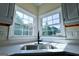 Kitchen sink with modern fixtures, white countertops and a view of the backyard at 165 Mcelwaney Way, Fayetteville, GA 30215