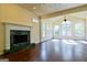 Open-concept living area with fireplace, hardwood floors, and many windows at 165 Mcelwaney Way, Fayetteville, GA 30215