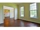 Bright living room featuring hardwood floors and two large windows at 165 Mcelwaney Way, Fayetteville, GA 30215