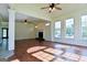 Spacious living room featuring hardwood floors, a fireplace, and large windows at 165 Mcelwaney Way, Fayetteville, GA 30215