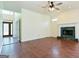 Large living room with hardwood floors, fireplace, and bright light at 165 Mcelwaney Way, Fayetteville, GA 30215