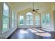 Bright sunroom with hardwood floors, many windows, and a ceiling fan at 165 Mcelwaney Way, Fayetteville, GA 30215