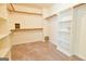 Large walk-in closet with carpeted floor and open shelving at 165 Mcelwaney Way, Fayetteville, GA 30215
