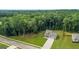 Aerial view of a well-maintained home and manicured lawn surrounded by mature trees at 132 Whitworth Dr # 15, Locust Grove, GA 30248