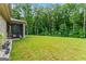 View of a lush backyard with green grass and mature trees, offering a peaceful outdoor space at 132 Whitworth Dr # 15, Locust Grove, GA 30248