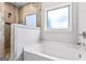 This bathroom features a luxurious soaking tub and walk-in shower with stylish tile surround at 132 Whitworth Dr # 15, Locust Grove, GA 30248