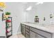 Double sink bathroom vanity with granite countertops, large mirror, and decorative accents at 132 Whitworth Dr # 15, Locust Grove, GA 30248