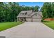 Beautiful home features a manicured lawn, two-car garage, and inviting front porch at 132 Whitworth Dr # 15, Locust Grove, GA 30248