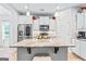 Modern kitchen featuring stainless steel appliances, marble countertops, and a center island with seating at 132 Whitworth Dr # 15, Locust Grove, GA 30248
