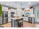 Well-lit kitchen with stainless steel appliances, light wood floors, and a center island with seating at 132 Whitworth Dr # 15, Locust Grove, GA 30248