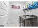 Well-equipped laundry room with modern washer and dryer, storage and a laundry-themed decorative sign at 132 Whitworth Dr # 15, Locust Grove, GA 30248