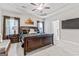 This bedroom boasts a tray ceiling with fan, stylish decor, and ample natural light at 132 Whitworth Dr # 15, Locust Grove, GA 30248