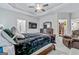 Spacious bedroom featuring a tray ceiling, a ceiling fan, TV, and walk-in closet at 132 Whitworth Dr # 15, Locust Grove, GA 30248