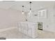 Bright basement bar area with seating, wine fridge and modern pendant lights at 4203 Harrogate Nw Dr, Atlanta, GA 30327