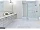 Luxurious bathroom with dual vanity, a glass-enclosed shower, and a soaking tub, all featuring marble accents at 4203 Harrogate Nw Dr, Atlanta, GA 30327