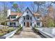 Stunning two-story home featuring manicured landscaping, symmetrical lines, a symmetrical roof, and a walkway to the front door at 4203 Harrogate Nw Dr, Atlanta, GA 30327