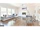 Well-lit living room featuring a fireplace, large windows, and modern furnishings at 4203 Harrogate Nw Dr, Atlanta, GA 30327