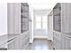 Well-organized walk-in closet with custom shelving and drawers, offering ample storage space, with a window for natural light at 4203 Harrogate Nw Dr, Atlanta, GA 30327