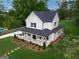 Aerial view showcasing the home's spacious yard, landscaping, and inviting covered porch at 61 Main St, Moreland, GA 30259