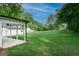 Expansive backyard featuring a covered patio, offering ample space for outdoor enjoyment at 61 Main St, Moreland, GA 30259