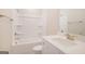 Bathroom features a shower-tub combo, vanity with white cabinets and brushed-nickel faucet at 61 Main St, Moreland, GA 30259