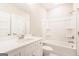 Bathroom features a tub and shower combination, a white vanity and brushed nickel faucet at 61 Main St, Moreland, GA 30259