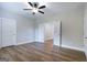 Large bedroom with hardwood floors, ceiling fan and two white doors, one with a view to the hall at 61 Main St, Moreland, GA 30259