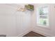 A tidy closet space with a window, clean white walls, wire shelving, and wood-look floors at 61 Main St, Moreland, GA 30259