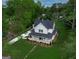Inviting two-story home with a charming front porch, lush lawn, and a long driveway at 61 Main St, Moreland, GA 30259