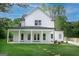 Stunning two-story home featuring a covered patio and a spacious, lush green lawn at 61 Main St, Moreland, GA 30259