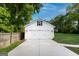 Detached two-car garage with a concrete driveway and ample parking space at 61 Main St, Moreland, GA 30259