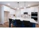 Modern kitchen featuring white cabinetry, stainless steel appliances, and a large center island at 61 Main St, Moreland, GA 30259