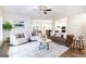Spacious living room with stylish furnishings, a ceiling fan, and hardwood floors at 61 Main St, Moreland, GA 30259