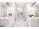 Bright main bathroom with double vanity, tile flooring and a glass enclosed shower at 61 Main St, Moreland, GA 30259