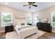 Inviting main bedroom featuring a plush bed, soft rug, and windows at 61 Main St, Moreland, GA 30259