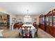 Spacious dining room featuring a fireplace, hardwood chairs, and a large china cabinet at 75 Antioch Rd, Mcdonough, GA 30252