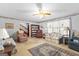 Bright living room featuring a floral ceiling border, ceiling fan, and large windows at 75 Antioch Rd, Mcdonough, GA 30252