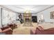 Cozy living room with a stone fireplace, ceiling fan, and floral wallpaper at 75 Antioch Rd, Mcdonough, GA 30252