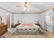Bright bedroom featuring a ceiling fan, carpeted floors, and bedside tables at 75 Antioch Rd, Mcdonough, GA 30252