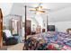 Spacious bedroom features a four-poster bed, ceiling fan, and doorway view to the bathroom at 75 Antioch Rd, Mcdonough, GA 30252