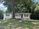 Charming brick home featuring a well-maintained lawn and beautiful mature trees for added curb appeal at 3129 Se Nursery Se Rd, Smyrna, GA 30082