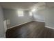 Basement bedroom with two windows, wood flooring, and a ceiling fan at 8427 Fredericksburg Ct, Jonesboro, GA 30238