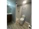 Bathroom features a shower, toilet, vanity, and wood-look flooring at 8427 Fredericksburg Ct, Jonesboro, GA 30238