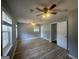 Bedroom with wood-look flooring, neutral walls, and two windows allowing natural light at 8427 Fredericksburg Ct, Jonesboro, GA 30238