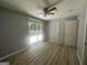 Bright bedroom features wood-look flooring, neutral walls, sliding glass door to the deck, and a ceiling fan at 8427 Fredericksburg Ct, Jonesboro, GA 30238