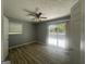 Bedroom featuring hardwood floors, ceiling fan, sliding glass door to balcony and a window at 8427 Fredericksburg Ct, Jonesboro, GA 30238